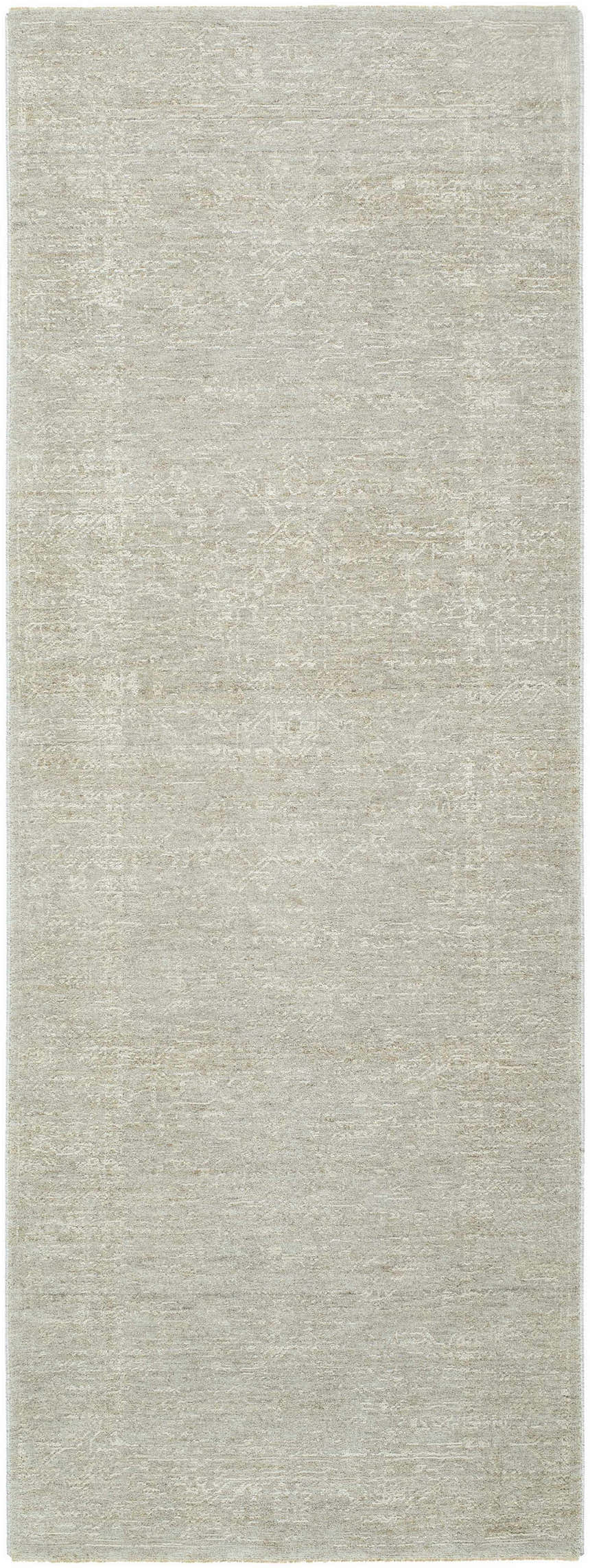 Close-up of the Catrin Area Rug, a machine-woven rug in light sage with a subtle traditional pattern. Design-Runner-273