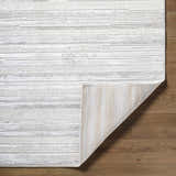 Close-up of the Cardea Area Rug showing its cream, ivory, and gray horizontal stripes and the rug's backing. Fold