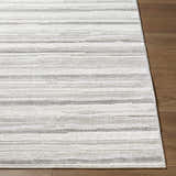 Close-up of the Cardea Area Rug showing its cream, ivory, and gray horizontal striped design and soft texture. Front