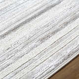 Close up of the Cardea Area Rug showing cream, ivory, and gray stripes and soft texture. Texture