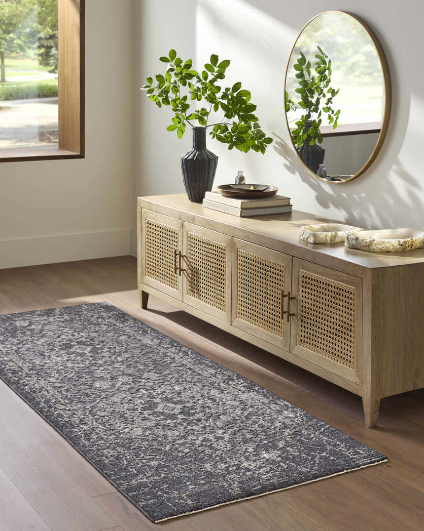Entryway with a Corina Black runner rug, wood floors, and a console table with a round mirror. Roomscene-Runner