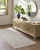 Entryway scene with a tan console table, round mirror, and the Corina Charcoal Area Rug runner. Roomscene-Runner