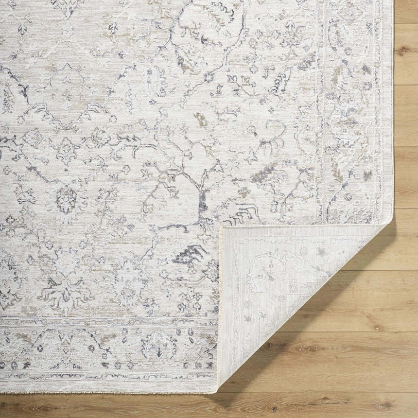 Close-up of the Corina Charcoal Area Rug showing its traditional floral pattern and cream, gray, and charcoal colors. Fold