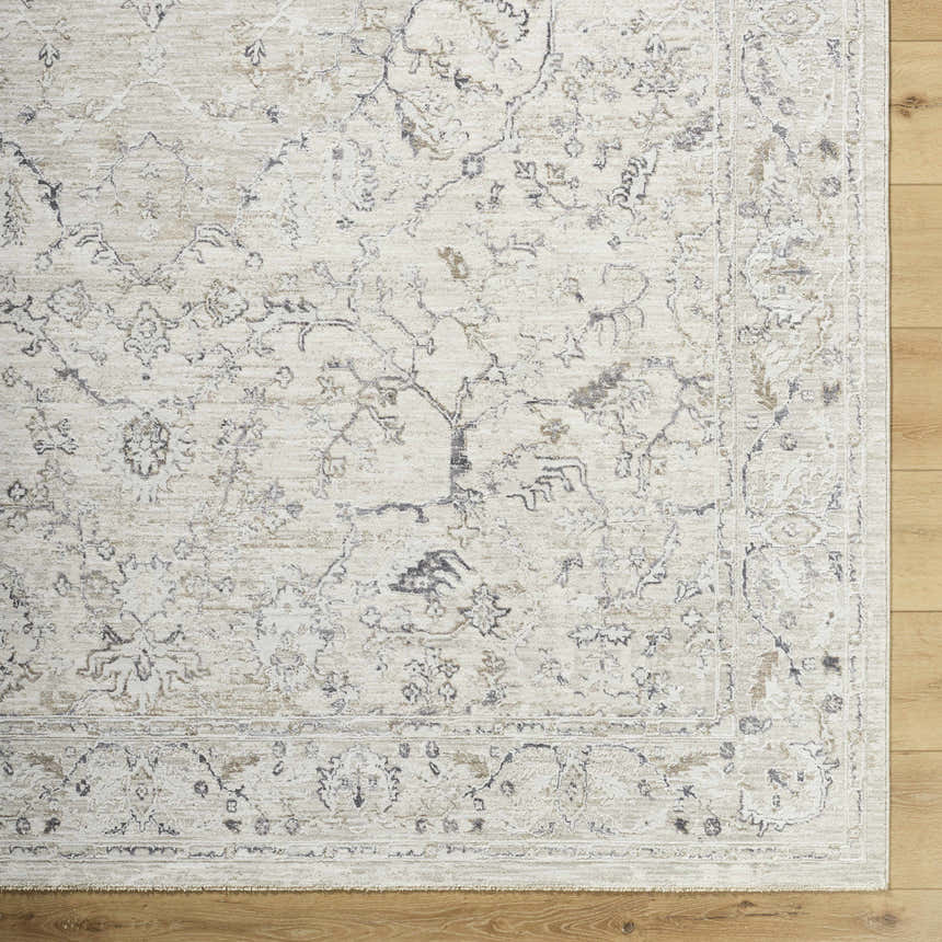 Close-up of the Corina Charcoal Area Rug, showcasing its traditional floral pattern in charcoal, cream, and tan hues. Corner