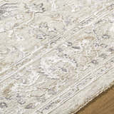 Close-up of the Corina Charcoal Area Rug showing its floral pattern, texture, and charcoal, cream, and ivory colors. Texture