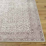 Close-up of the Spokane Machine Woven rug. Farmhouse style rug with burnt orange and cream floral pattern on wood floor. Front