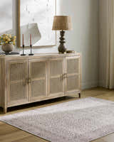 Living room scene with Spokane Machine Woven rug in burnt orange and cream, styled with a wooden cabinet and decor. Roomscene-Rectangle
