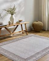 Entryway with Rainier Cottage Border Brown Washable Rug. Farmhouse style with wood bench, vases, and woven basket. Roomscene-Rectangle