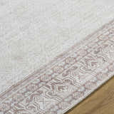 Close-up of the Rainier Cottage Border Brown Washable Rug showing the cream color and traditional border pattern. Texture