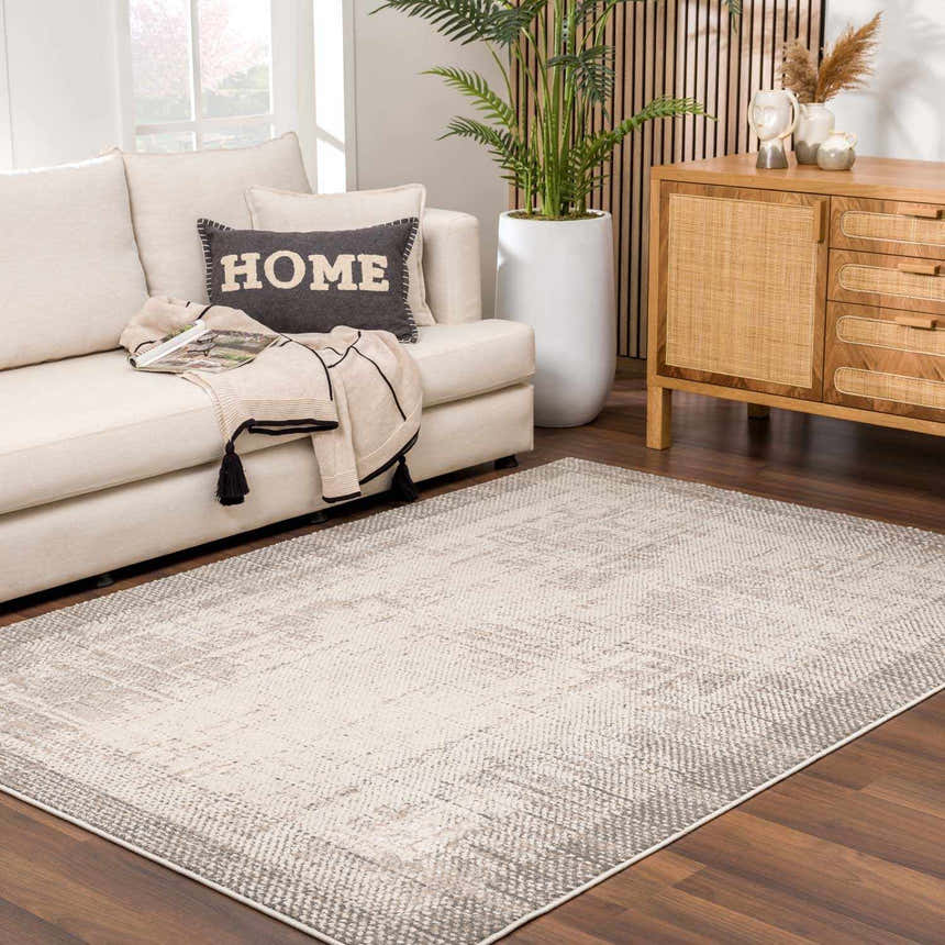 Living room scene with Colson Sage Area Rug, cream sofa, wood cabinet, and neutral tones. Roomscene-Rectangle