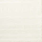 Close-up of a hand-tufted Charan Ivory Cream area rug with a raised, geometric pattern and textured wool. Corner