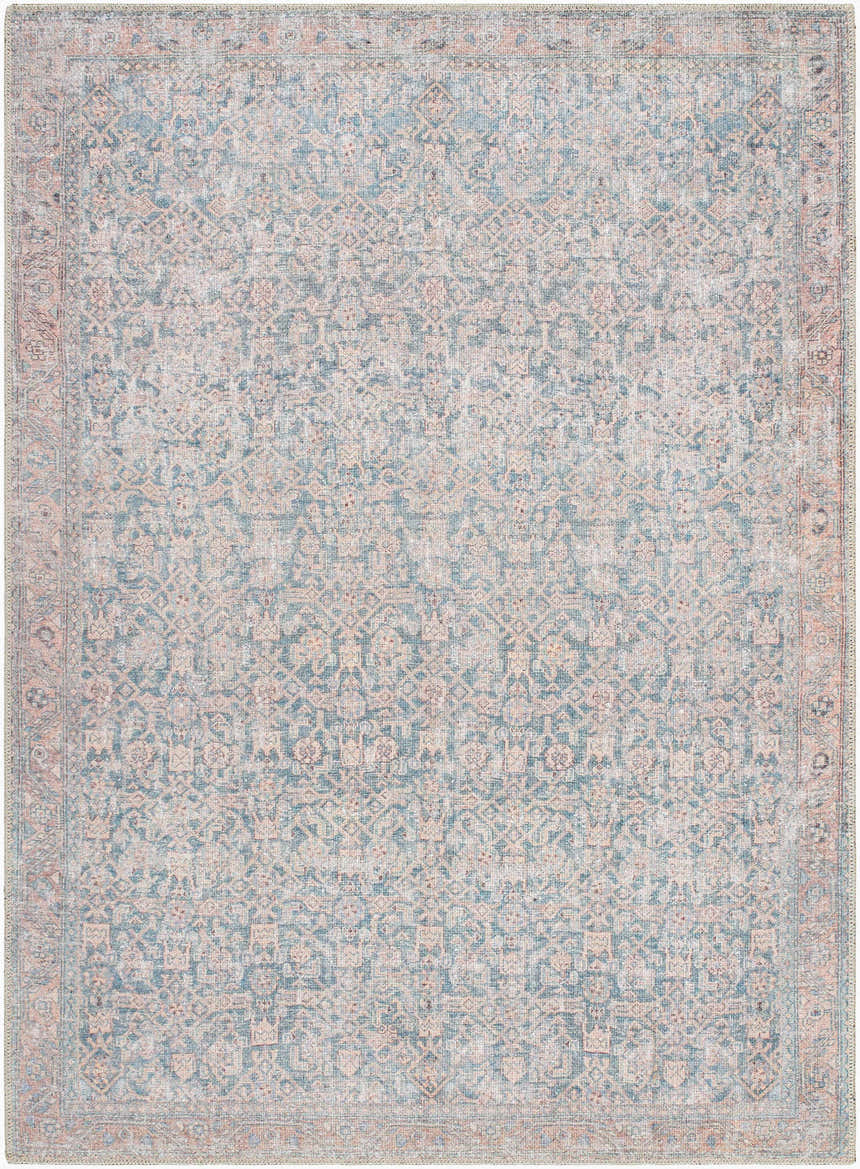 Close-up of a Crevan Washable Area Rug. Traditional design in denim blue, tan, and light red colors. Machine woven. Design-Rectangle
