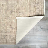 Close-up of the Fetscher V Vintage Damask Area Rug showing the tan damask pattern, ivory backing, and texture. Fold