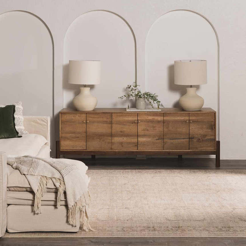 Living room scene with a neutral Fetscher V Vintage Damask Area Rug, wood cabinet, and cream sofa. Roomscene-Rectangle