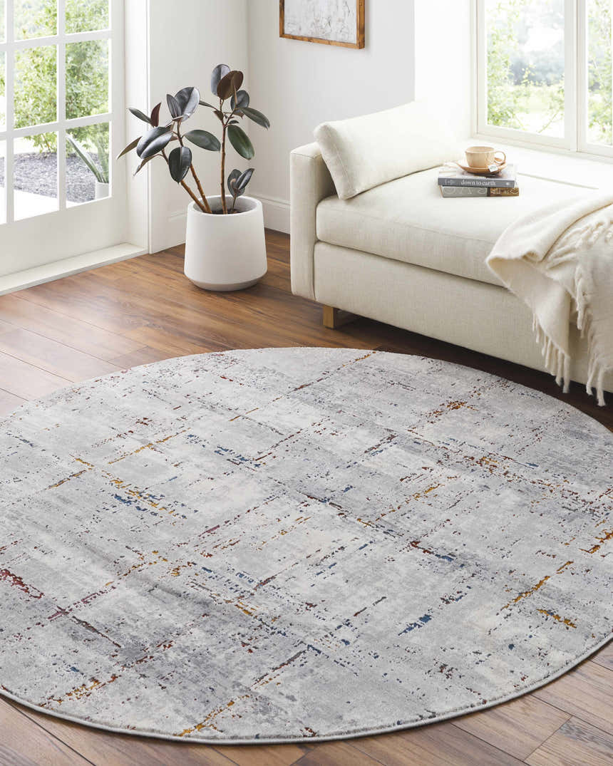 Bright sunroom with Concordia Faux Silk Rug, round shape, gray with burgundy, burnt orange, and blue accents. Roomscene-Round