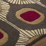 Close up of the hand-tufted Canovanas Modern Wool Rug showing its brown, tan, and dark red floral pattern. Texture
