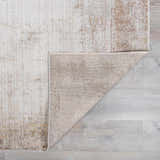 Close-up of the Myrtle Avenue Galey Alix x LIVABLISS GAMY-2303 area rug showing its camel, cream, and brown abstract pattern. Fold