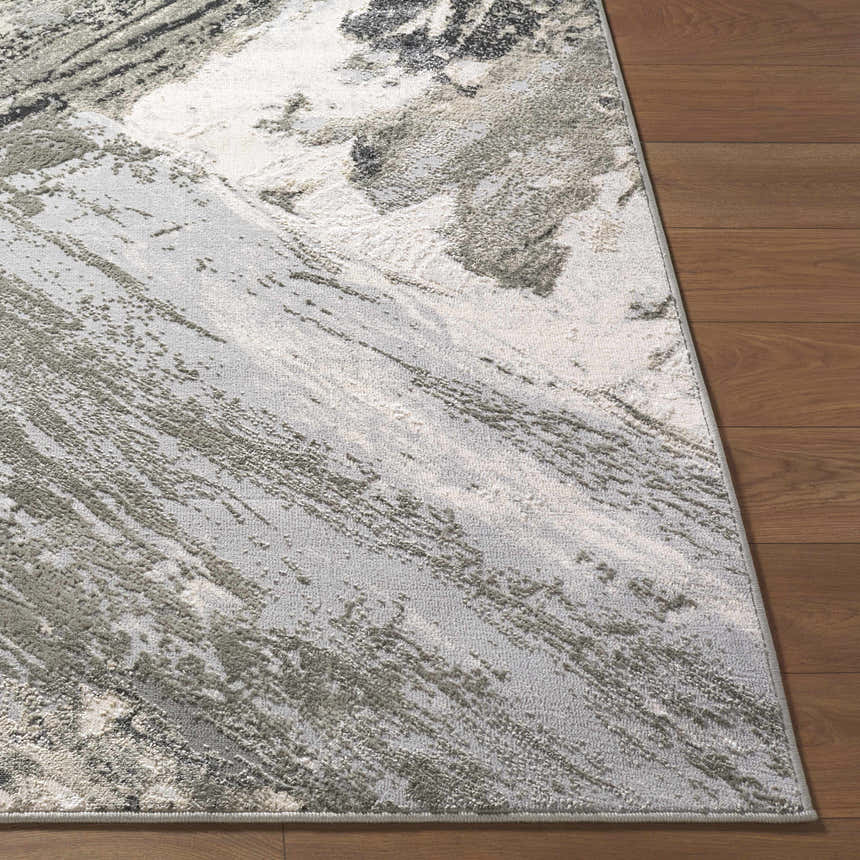 Close-up of the Chaeli Area Rug showing its beige, ivory, charcoal and light slate abstract pattern and textured weave. Front