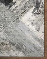 Close-up of the Chaeli Area Rug. Contemporary design with beige, black, charcoal, ivory, and light slate colors. Corner