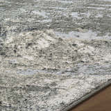 Close-up of the Chaeli Area Rug showing its beige, charcoal, and ivory contemporary pattern and soft texture. Texture
