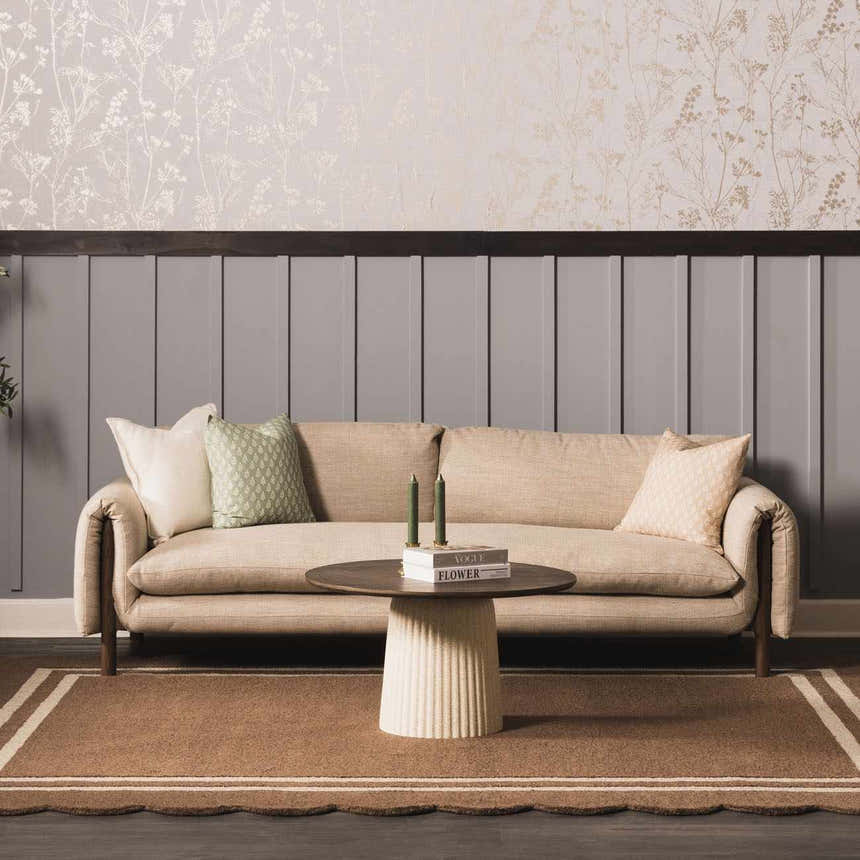 Living room scene with a Chogan Chocolate Brown area rug, beige sofa, and round coffee table. Roomscene-Rectangle