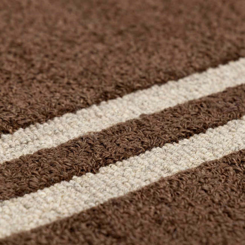 Close-up of the wool Chogan Chocolate Brown Area Rug showing brown and beige stripes and textured, hand-tufted construction. Texture