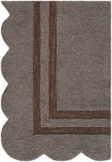 Close-up of the hand-tufted Chogan Charcoal Area Rug. Features a brown border and scalloped edge. 100% Wool texture. Corner