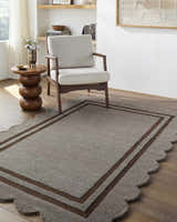 Living room scene with a Chogan Charcoal Area Rug, beige chair, and wood side table on hardwood floors. Roomscene-Rectangle