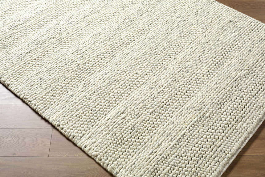 Close-up of the hand woven Clarke Textured Braided Stripe - Dark Beige Area Rug showing wool texture and medium brown color. Corner