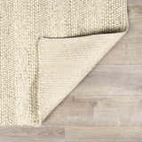 Close-up of the Clarke Textured Braided Stripe Rug in dark beige, showing the hand-woven texture and backing. Fold
