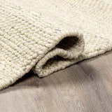 Close-up of the textured, hand-woven Clarke Textured Braided Stripe - Dark Beige Area Rug. Medium brown, 100% wool. Fold