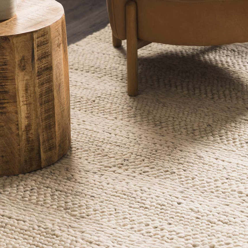 Close up of the Clarke Textured Braided Stripe rug in dark beige, showing its hand woven wool texture. Roomscene-Rectangle