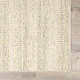 Close-up of the Clarke Textured Braided Stripe Rug in dark beige. Hand-woven wool rug with a textured, striped pattern. Swatch