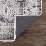 Close-up of the Off White Holi-4602 Washable Area Rug showing its traditional vintage pattern, fringed edge, and gray backing. Fold