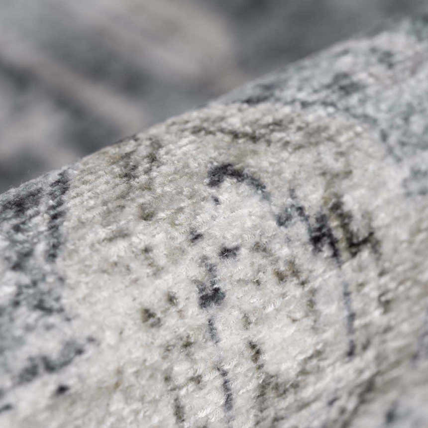 Close-up of the Off White Holi-4602 Washable Area Rug, showing its texture and beige, charcoal, and gray traditional vintage pattern. Fold