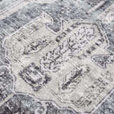 Close-up of the Off White Holi-4602 Washable Area Rug, featuring a traditional vintage pattern in beige, charcoal, and gray. Texture