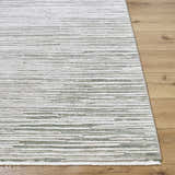 Close-up of the Corwin 3D Striped Washable Area Rug. Cream, gray, sage, and tan stripes on a machine woven polyester rug. Front