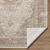 Close-up of the Charae Ivory Area Rug showing beige, sandstone, and taupe traditional pattern and texture. Fold