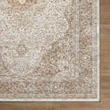 Close-up of Charae Ivory rug showing beige, sandstone, and taupe traditional pattern on wood floor. Corner