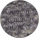 Close-up of the round Alexei Area Rug. Features a traditional pattern in black, charcoal, gray, and tan. Design-Round-53