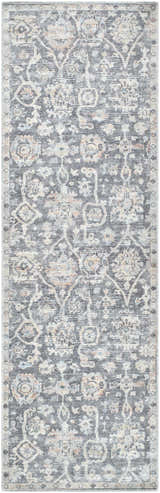 Close-up of the Eleni rug. Machine woven rug in beige, black, burnt orange, denim, and gray with a traditional pattern. Design-Runner-27710