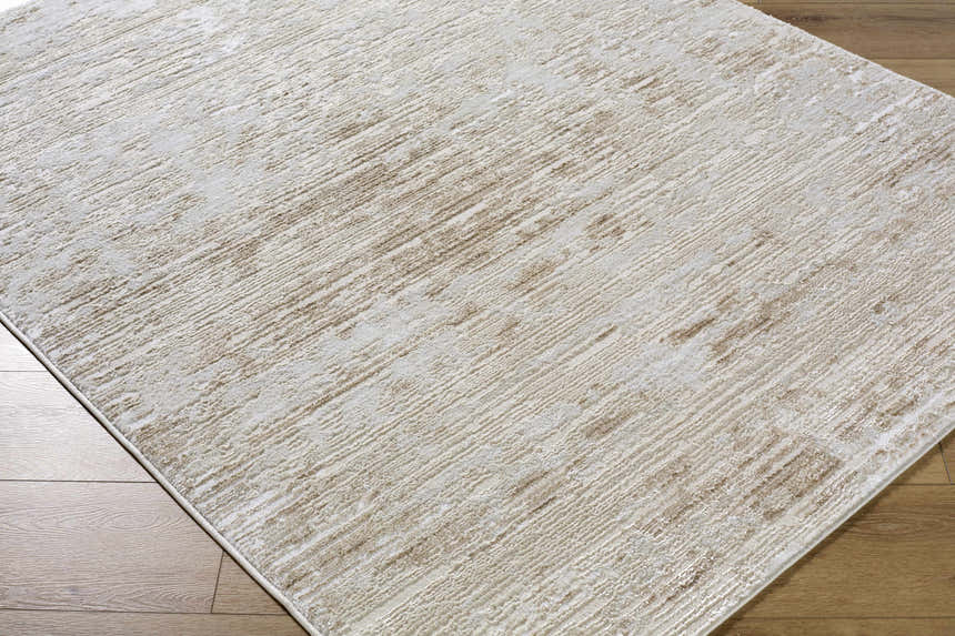 Close up of the contemporary Candie Beige Area Rug showing its cream, tan, and beige pattern and texture. Corner