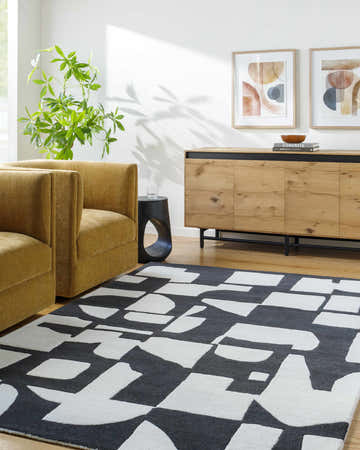 Living room scene with a Celous Area Rug, ivory and jet black geometric pattern, mustard chairs, and wood cabinet. Roomscene-Rectangle
