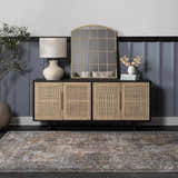 Entryway with a beige and gray Dagatan Washable Area Rug, black console table, gold mirror, and blue paneled wall. Roomscene-Rectangle