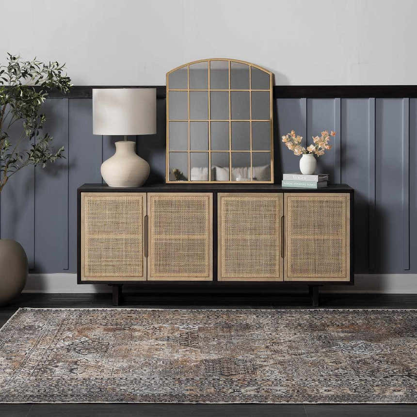 Entryway with a beige and gray Dagatan Washable Area Rug, black console table, gold mirror, and blue paneled wall. Roomscene-Rectangle