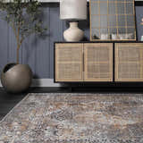 Living room scene with beige, black, and gray Dagatan Washable Area Rug, dark wood floors, and a rattan cabinet. Roomscene-Rectangle