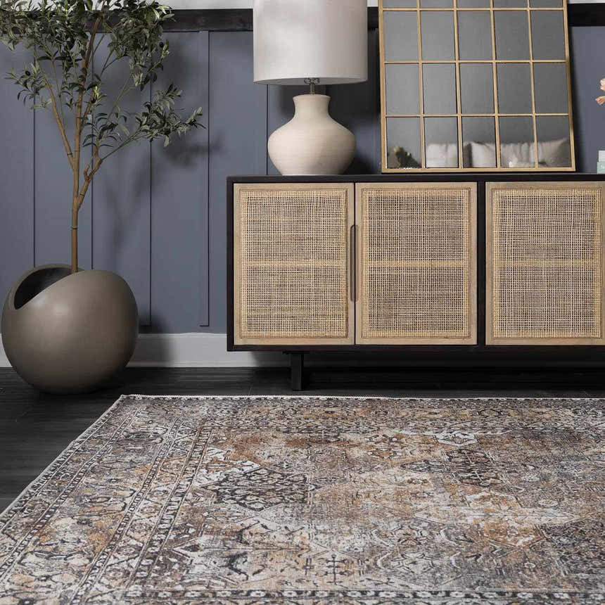 Living room scene with beige, black, and gray Dagatan Washable Area Rug, dark wood floors, and a rattan cabinet. Roomscene-Rectangle