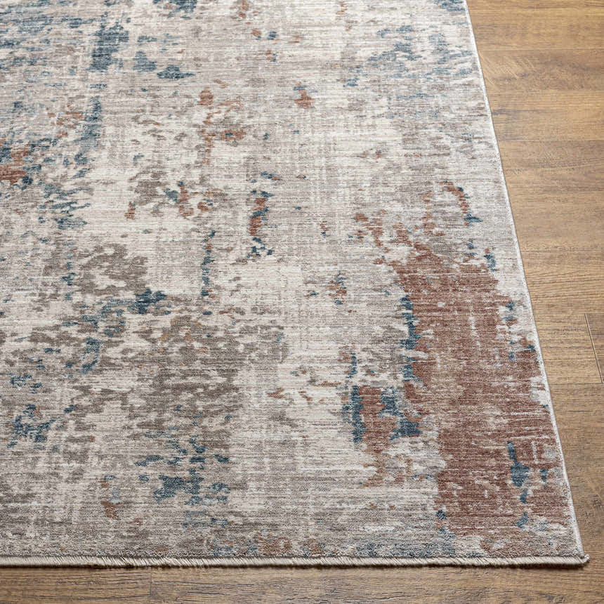 Close-up of the Danlugan Area Rug showing a contemporary charcoal, cream, brown, and blue abstract pattern. Front