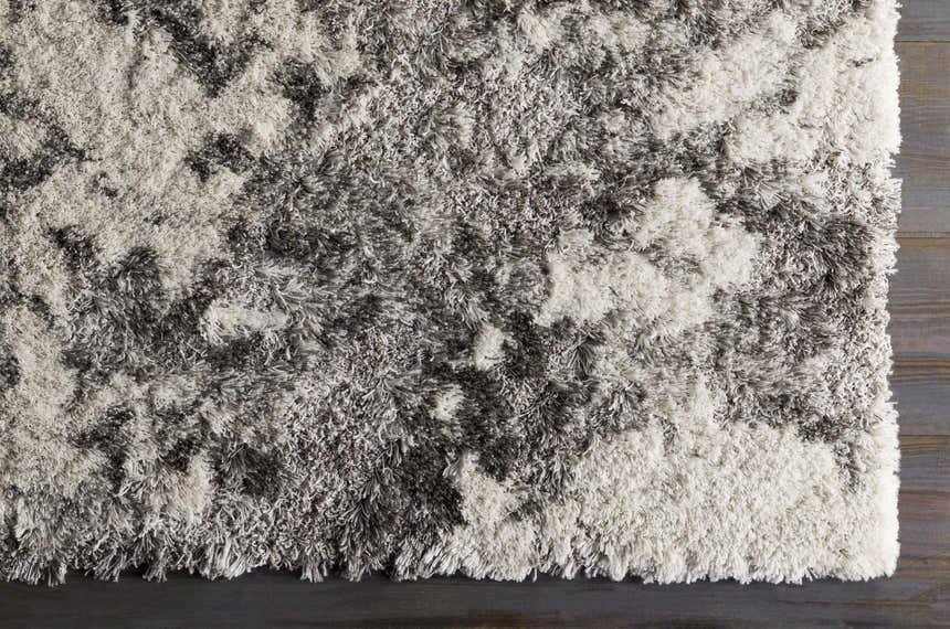 Close-up of the Livabliss Alta Shag rug. Gray, light gray, and off-white shag texture on a machine woven rectangle rug. Swatch