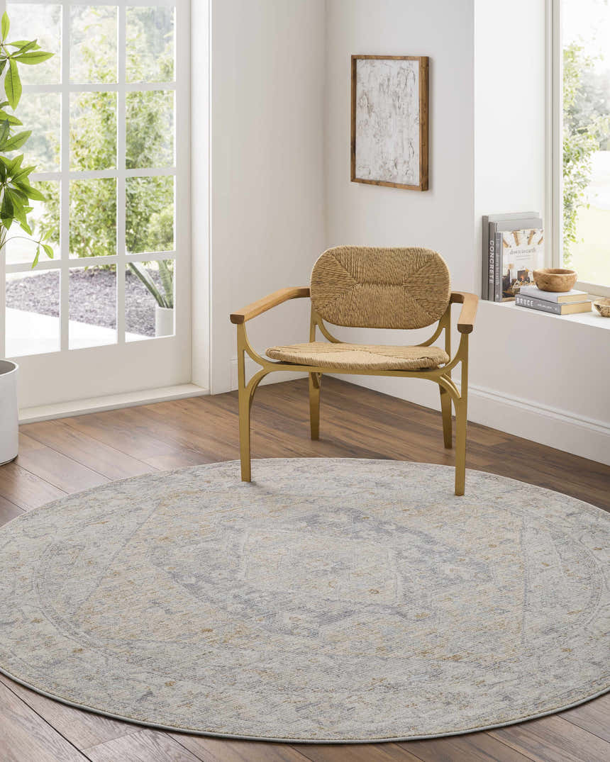 Bright living room with a round Deena Thick Luxe Area Rug in gray, brown, and teal under a woven chair. Roomscene-Round
